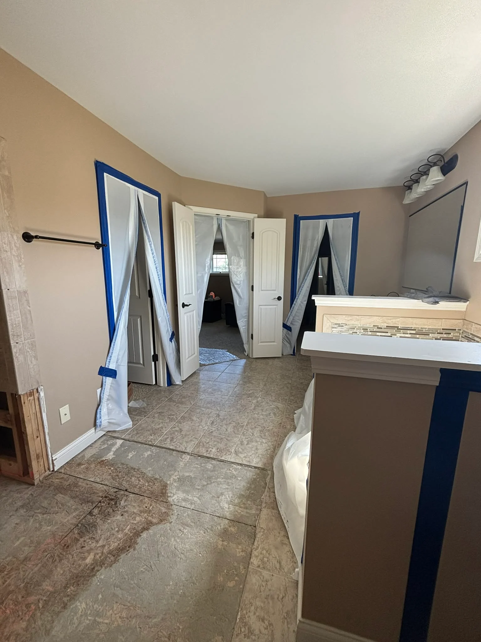 Bathroom renovation with ceramic tile flooring, fresh paint, new doors, and vanity with tile backsplash in Martinsville, IN
